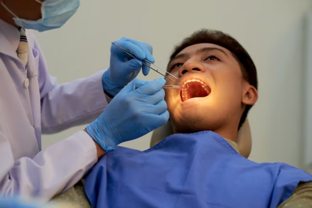 dentist examining a patient before wisdom teeth removal treatment