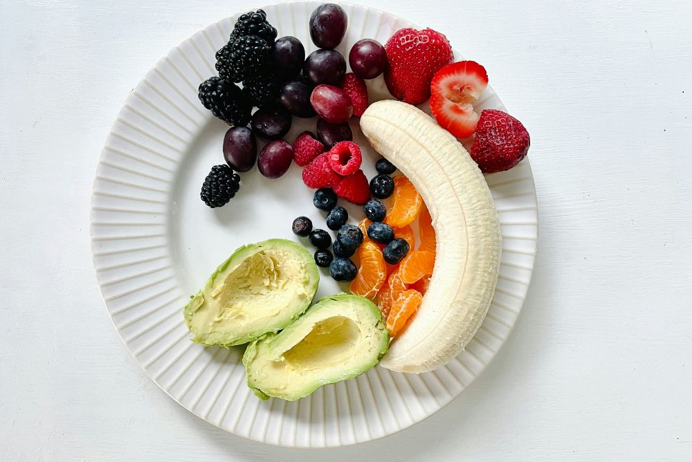 soft fruits and avocado on a plate illustrating what you can eat after wisdom teeth removal